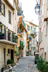 Alley amidst houses against clear sky