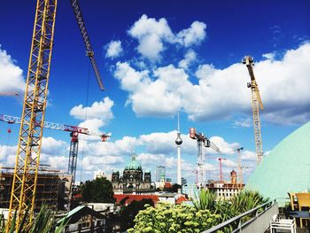 Low angle view of crane against sky