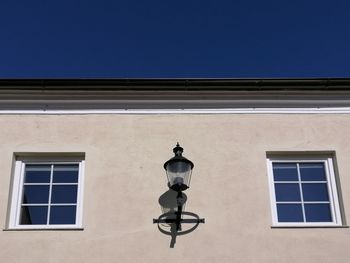 Low angle view of street light against building