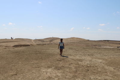 Rear view of woman walking on land