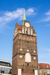 Low angle view of clock tower against blue sky