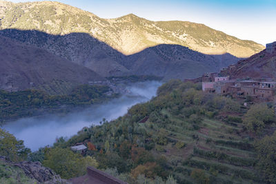 High angle view of land and mountains against sky