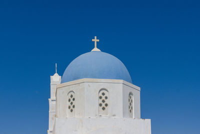 Low angle view of greek church against clear blue sky