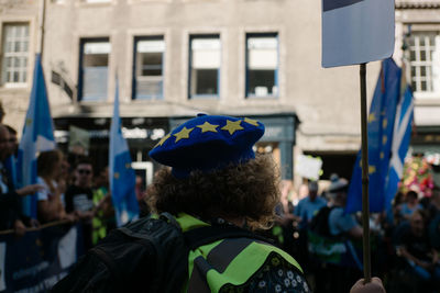 Rear view of people standing on street