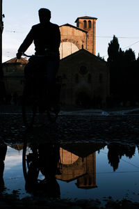 Reflection of building in lake against sky