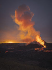 Picturesque view of active volcano with hot lava located against cloudy sunset sky in iceland