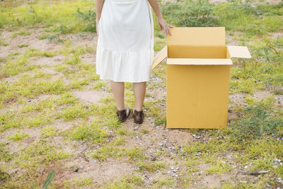 Low section of woman standing on field