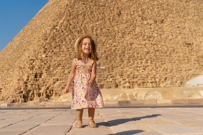 Cute little girl dancing in front of the cheops pyramid on the giza plateau