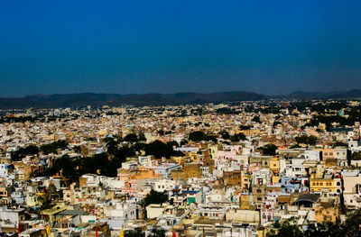 High angle view of townscape against blue sky