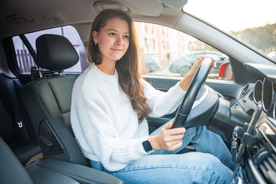 Portrait of woman sitting in car