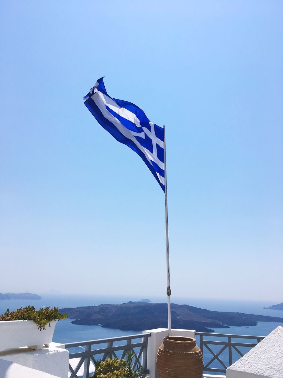 flag, patriotism, wind, blue, day, no people, outdoors, sea, water, clear sky, nature, nautical vessel, beauty in nature, sky