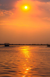 Scenic view of sea against orange sky