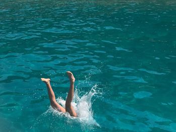 Low section of woman diving in sea