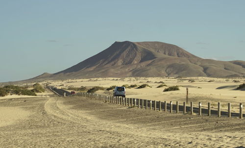 Scenic view of landscape and mountains against clear sky