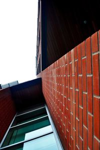 Low angle view of brick wall against clear sky