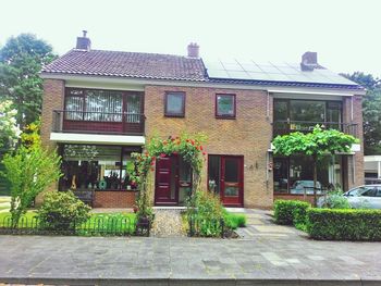 Exterior of house by building against sky