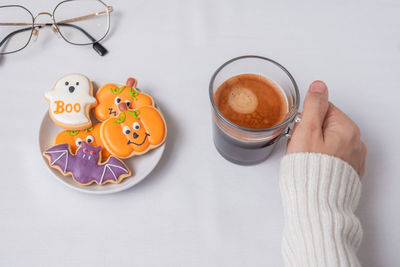 Cup of coffee on table against white background