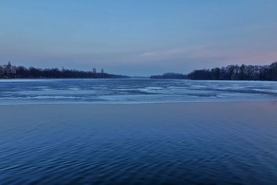 Scenic view of frozen lake against sky during winter