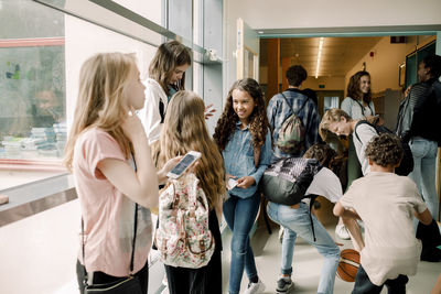 Middle and junior high students in school corridor during lunch break