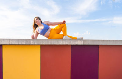 Low angle view of lying on wall