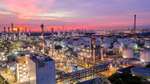 High angle view of illuminated city against sky at sunset