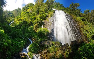 Low angle view of waterfall against sky