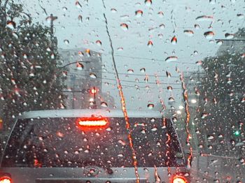 Road seen through wet car windshield