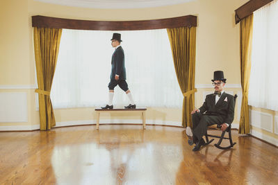 Young man standing on hardwood floor at home