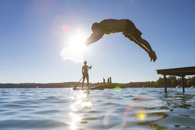 Silhouette of people in sea