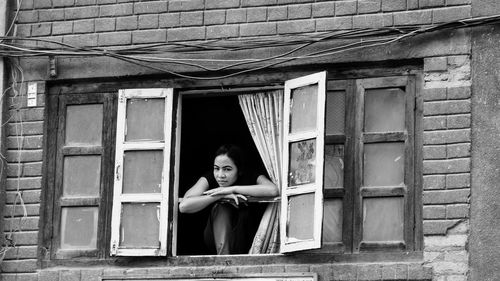 Portrait of woman against building