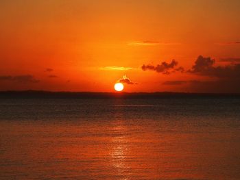 Scenic view of sea against romantic sky at sunset