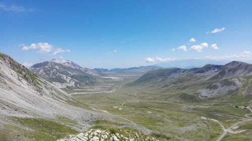 Scenic view of mountains against cloudy sky