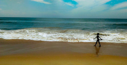 Full length of man on beach against sky