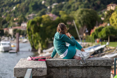 Woman sitting on a wall