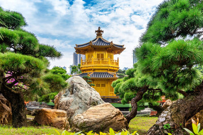 Temple by building against sky