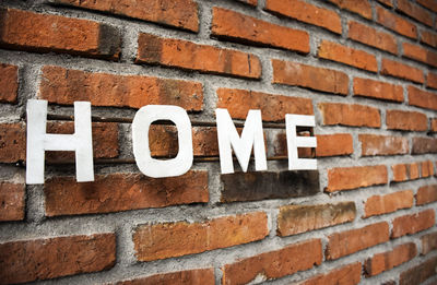 Close-up of text on brick wall