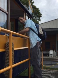 Man standing by built structure against sky