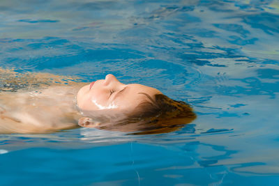 High angle view of woman swimming in pool