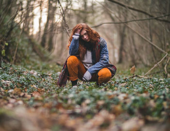 Woman sitting in forest