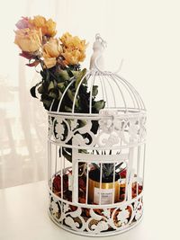 Close-up of flower vase on table against white background