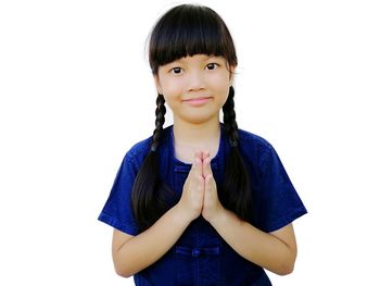 Portrait of a smiling young woman against white background