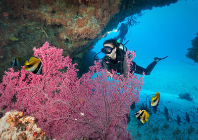 Full length of young woman scuba diving in sea