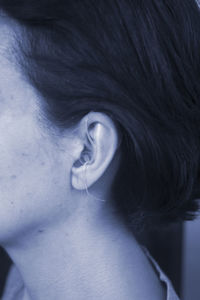 Close-up of woman with hearing aid