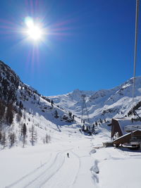 Scenic view of snow covered field against sky