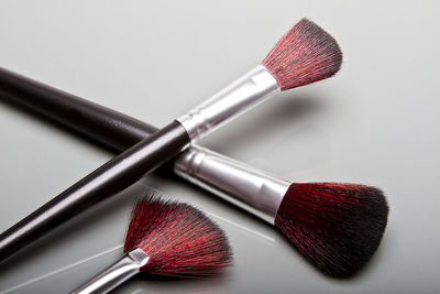 High angle view of make-up brushes on gray background