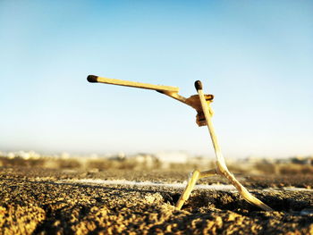 Close-up of matchstick art on road against clear sky