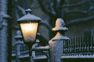 Close-up of snow on metal fence during winter