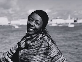 Portrait of smiling woman standing in sea