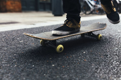 Young skateboarder on the street, partial view