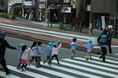 People crossing road in city